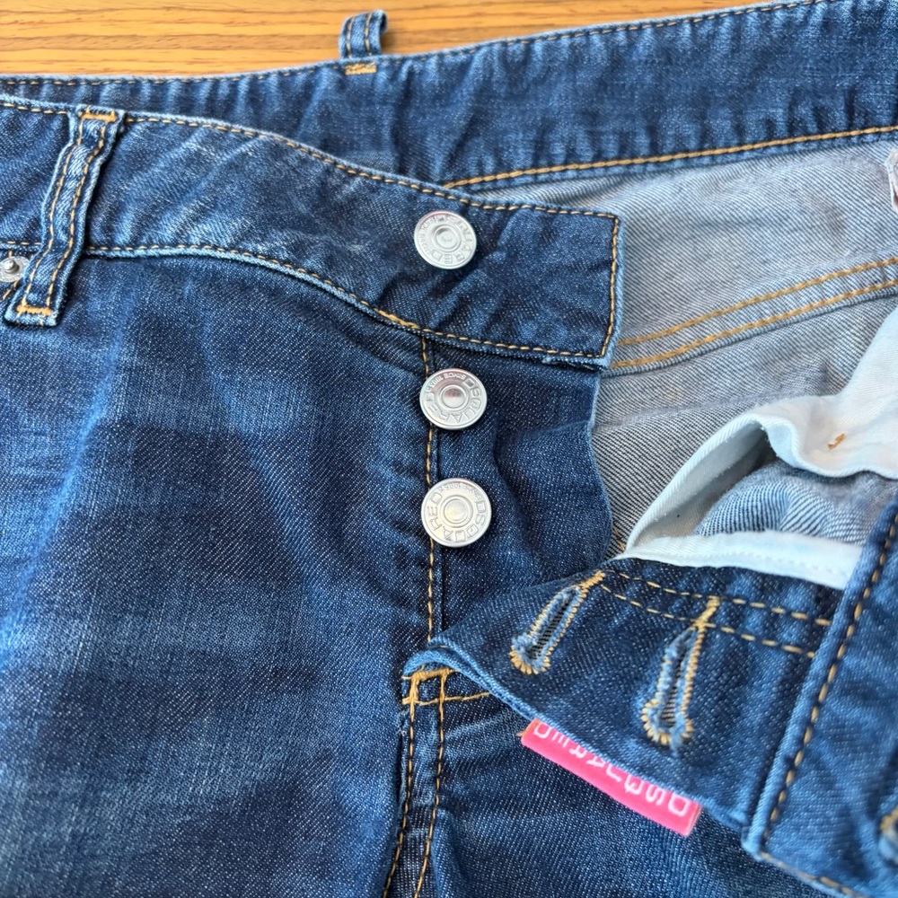 DSQUARED2 Italy distressed jeans with red metal maple leaf on back pocket